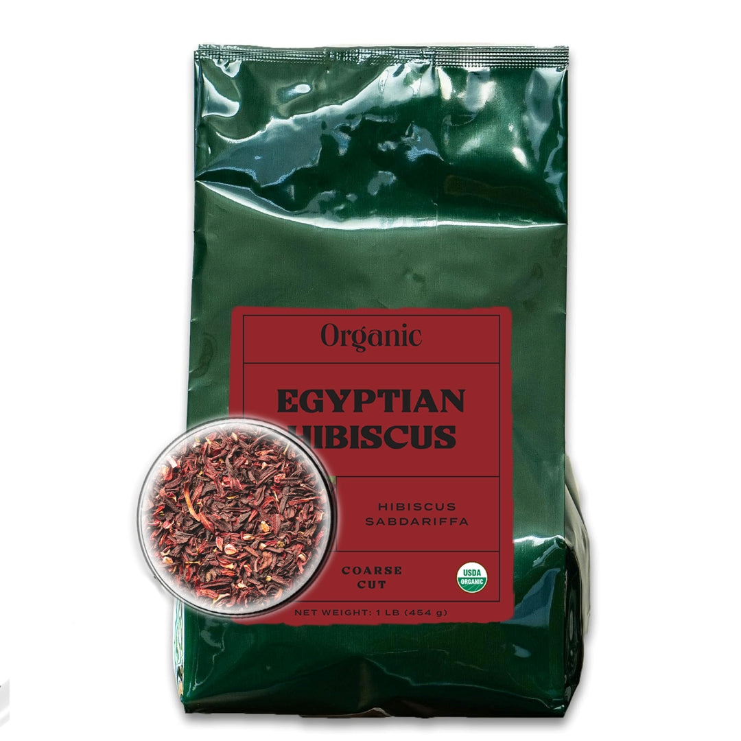 A dark green bag with a deep red front label and a microscopic close up view of coarse cut hibiscus, filled with organic Egyptian hibiscus.