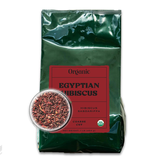 A dark green bag with a deep red front label and a microscopic close up view of coarse cut hibiscus, filled with organic Egyptian hibiscus.