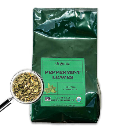 A dark green bag with a bright green front label with an image of a peppermint leaves filled with one pound of peppermint leaves.